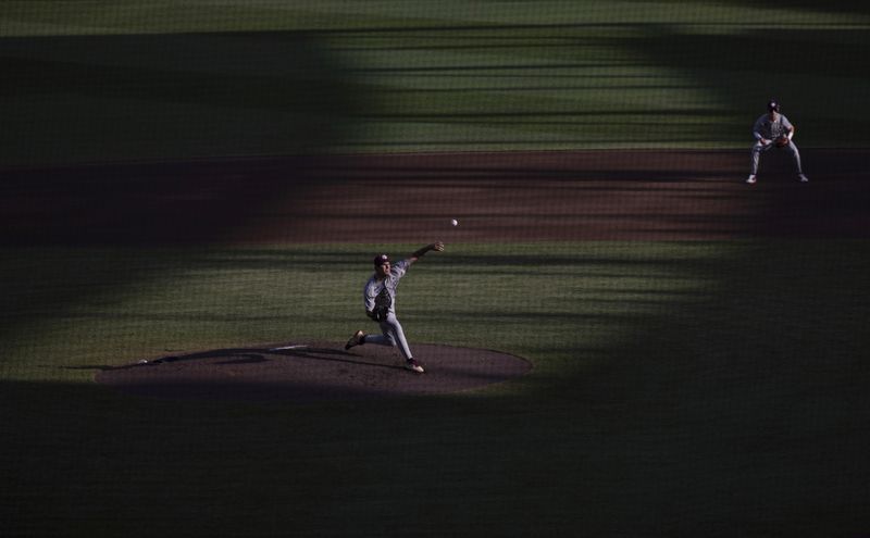 Texas A&M starting pitchers Ryan Prager throws to a Tennessee batter during the first inning in Game 1 of the NCAA College World Series baseball finals in Omaha, Neb., Saturday, June 22, 2024. (AP Photo/Rebecca S. Gratz)