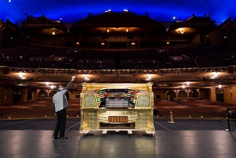 Ken Double, one of two Fox Theatre organists, takes a photo of Mighty Mo before it was reinstalled Tuesday. The organ console just underwent a year-long renovation. Ben Gray for the Atlanta Journal-Constitution