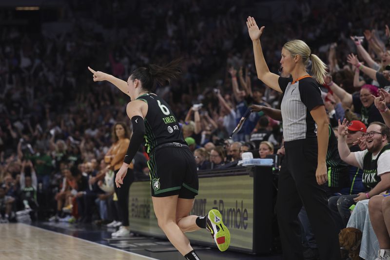 Minnesota Lynx forward Bridget Carleton (6) reacts after scoring a 3-point basket during the first half of Game 1 of a WNBA basketball semifinals against the Connecticut Sun, series Sunday, Sept. 29, 2024, in Minneapolis. (AP Photo/Stacy Bengs)