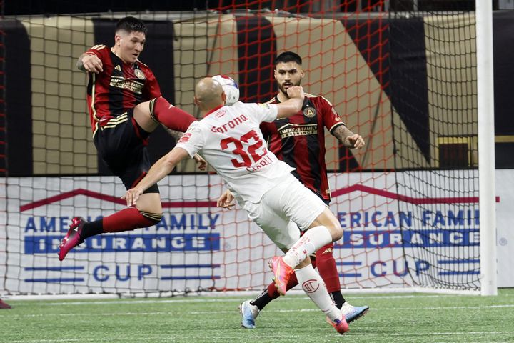 Atlanta United midfielder Franco Ibarra (14) battles for possession against Toluca's forward Carlos Gonzalez (32) during the first half of an exhibition match on Wednesday, Feb 15, 2023, in Atlanta.

 Miguel Martinez / miguel.martinezjimenez@ajc.com