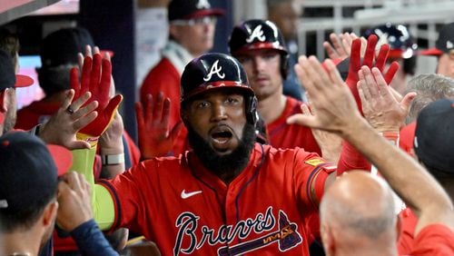 Braves designated hitter Marcell Ozuna celebrates with teammates after hitting three-run home run during the eighth inning at Truist Park on Friday, July 5, 2024 in Atlanta. (Hyosub Shin / AJC)