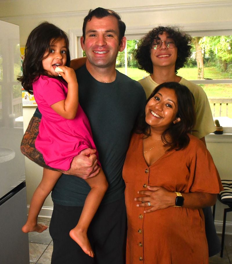 Sahar Siddiqi (right) poses in her Atlanta home with her husband Gabriel Johnson, their 3 1/2-year-old daughter Safina and 15-year-old nephew Isa, who spent the summer living with the family. 
(CHRIS HUNT FOR THE ATLANTA JOURNAL-CONSTITUTION)