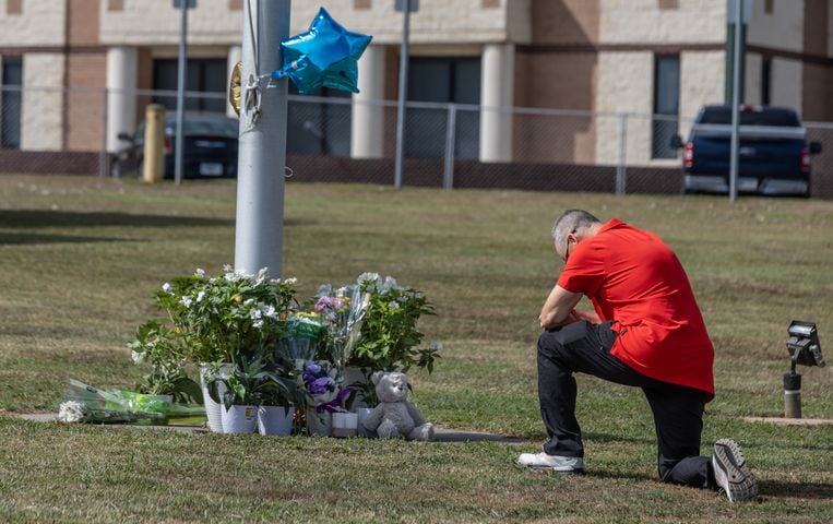 Students and well wishers arrived with flowers to place at the flag pole at Apalachee High School in Winder on Thursday, Sept. 5, 2024. A 14-year-old is accused of shooting and killing two fellow students and two teachers and injuring nine others at Apalachee High School on Wednesday. (John Spink/AJC)