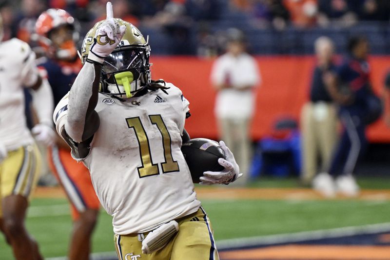 Georgia Tech running back Jamal Haynes (11) celebrate a touchdown during the second half of an NCAA football game against Syracuse on Saturday, Sept. 7, 2024 in Syracuse, N.Y. Syracuse won 31-28. (AP Photo/Hans Pennink)