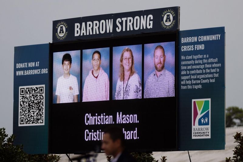 A electronic billboard showing 14-year-old Apalachee High School students Christian Angulo and Mason Schermerhorn, and teachers Cristina Irimie and Richard Aspinwall at a vigil at Jug Tavern Park on Sept. 6 in Winder, Ga. A 14-year-old Apalachee High School student is accused of shooting and killing the four and injuring nine others at the Barrow County high school on Wednesday, Sept. 4. (Arvin Temkar/AJC)