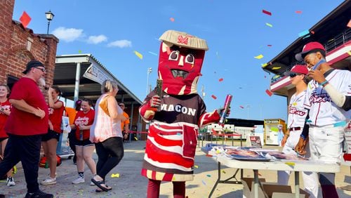 Mascot "Kevin Bacon" greets Macon Bacon fans at Luther Williams Field on opening night in Macon, Georgia. The Macon Bacon team plays in a collegiate baseball summer league. (Joe Kovac Jr. / AJC)