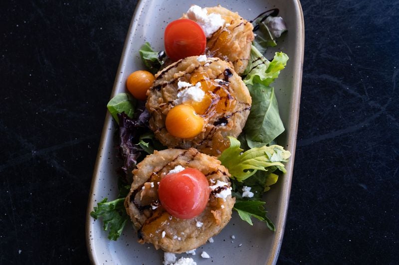 Sundae Cafe’s fried green tomato appetizer is sprinkled with cheese. (Rosana Lucia for The Atlanta Journal-Constitution)   