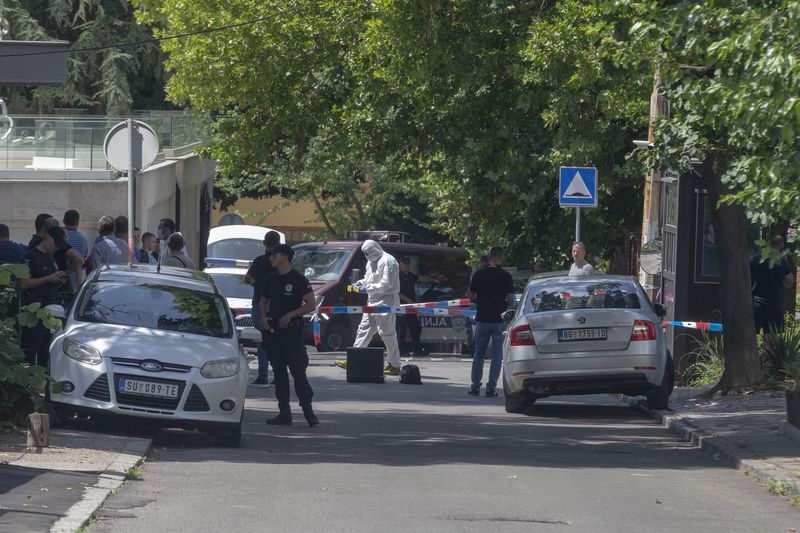 Police officers work at a crime scene close to the Israeli embassy in Belgrade, Serbia, Saturday, June 29, 2024. An attacker with a crossbow wounded a Serbian police officer guarding the Israeli Embassy in Belgrade. Serbia’s interior ministry says the officer responded by fatally shooting the assailant. (AP Photo/Marko Drobnjakovic)