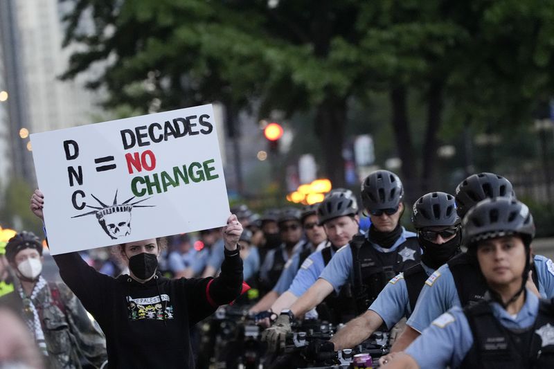 Protesters march passed a police line prior to the start of the Democratic National Convention Sunday, Aug. 18, 2024, in Chicago. (AP Photo/Frank Franklin II)