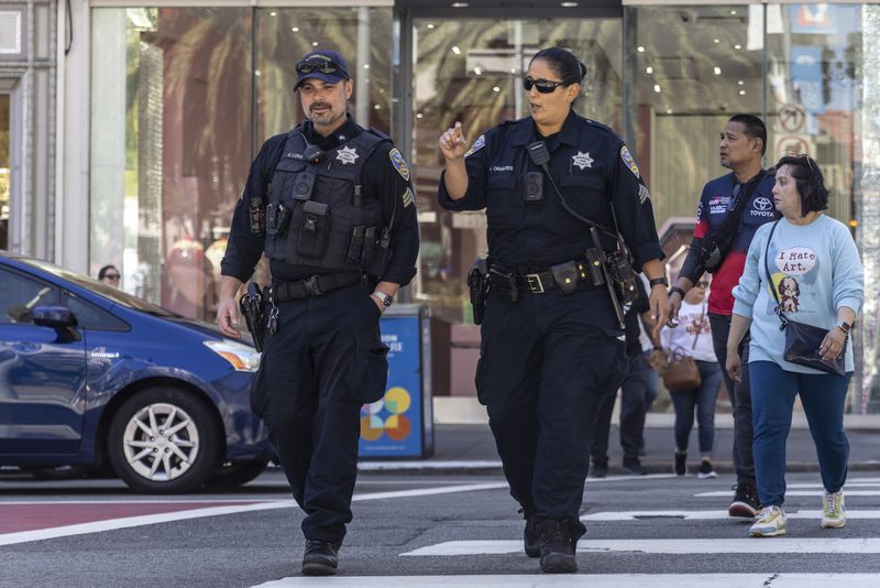 Officers with the San Francisco Police Department patrol in Union Square, the morning after San Francisco 49ers rookie wide receiver Ricky Pearsall was shot in the chest during an attempted robbery nearby, , in San Francisco, Sept. 1, 2024.(Stephen Lam/San Francisco Chronicle via AP)