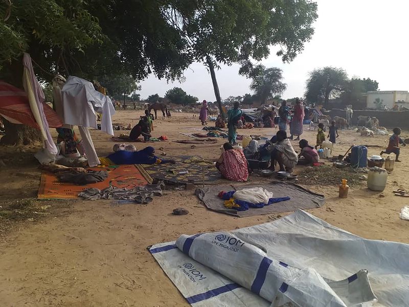 FILE - Residents displaced from a surge of violent attacks squat on blankets and in hastily made tents in the village of Masteri in west Darfur, Sudan, on July 30, 2020. (Mustafa Younes via AP, File)