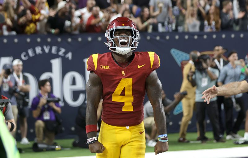 Southern California running back Woody Marks (4) celebrates after scoring the winning touchdown during the second half of an NCAA college football game against LSU, Sunday, Sept. 1, 2024, in Las Vegas. (AP Photo/Steve Marcus)