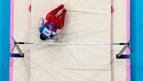 Brody Malone, of United States, falls from the bar during a men's artistic gymnastics qualification round at the 2024 Summer Olympics, Saturday, July 27, 2024, in Paris, France. (AP Photo/Morry Gash)