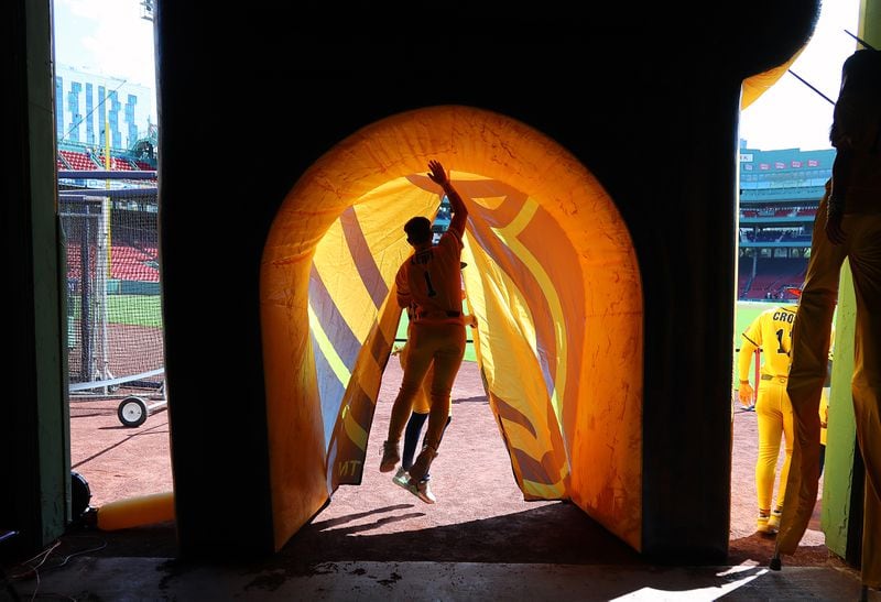 Savannah Bananas' Bill LeRoy jumps inside the tunnel leading onto the outfield of Fenway Park after greeting fans under the grandstands.  The Savannah Bananas took their World Tour to a sold-out Fenway Park on Saturday, June 8, 2024, as they played the Party Animals before over 37,000 fans in Boston.  (John Tlumacki/The Boston Globe)