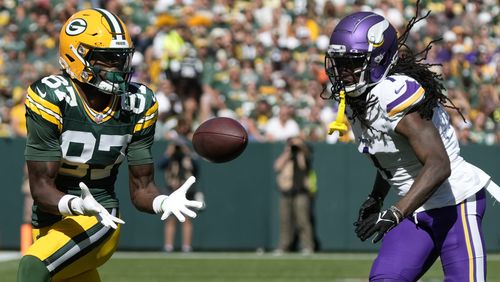 Green Bay Packers wide receiver Romeo Doubs (87) makes a catch past Minnesota Vikings cornerback Shaq Griffin, right, during the first half of an NFL football game Sunday, Sept. 29, 2024, in Green Bay, Wis. (AP Photo/Morry Gash)