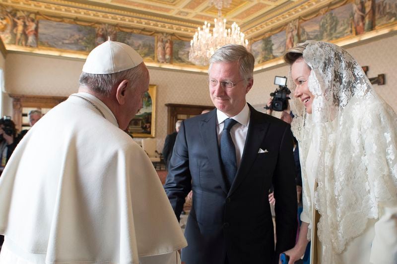 FILE — Pope Francis, left, greets Belgium's King Philippe, center, and Belgium's Queen Mathilde, at the end of a private audience at the Vatican, Monday, March 9, 2015. (AP Photo/Gabriel Bouys, Pool, File)