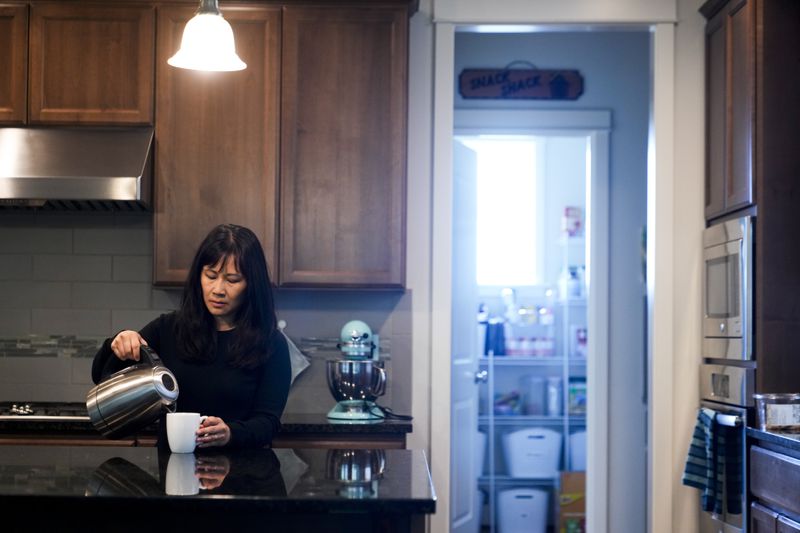 Ellen Lo Hoffman, the co-founder of Soul Reparations, a nonprofit providing free spiritual support to women, makes tea at her home Wednesday, Aug. 21, 2024, in Bothell, Wash. (AP Photo/Lindsey Wasson)