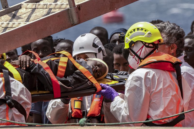 Migrants disembark at the port of "La Estaca" in Valverde at the Canary island of El Hierro, Spain, Monday, Aug. 26, 2024, after a thirteen-day voyage by boat from the coast of Senegal. (AP Photo/Maria Ximena)