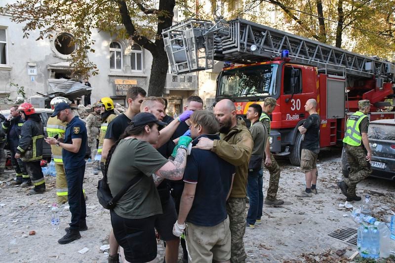 Medics give first aid to Yaroslav Bazylevych, who lost his family in a Russian missile attack in the western city of Lviv, Ukraine, Wednesday, Sept. 4, 2024. Bazylevych's wife, Yevgenia, and their three daughters - Darina, 18, Emilia, 7, and Yaryna, 21 - all died when Russian missile hit their home. (AP Photo/Mykola Tys)