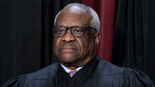 FILE - Associate Justice Clarence Thomas joins other members of the Supreme Court as they pose for a group portrait in Washington, Oct. 7, 2022. The Democratic chairman of the Senate Finance Committee said Monday, Aug. 5, 2024, that Thomas failed to publicly disclose additional travel on GOP megadonor Harlan Crow's private jet. Senator Ron Wyden of Oregon wrote to Crow's lawyer asking about the trip. Wyden is backing an election-year push to tighten the high court's ethics rules. (AP Photo/J. Scott Applewhite, File)