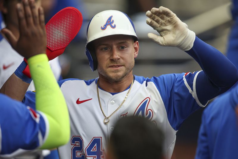 Atlanta Braves' Jarred Kelenic (24) celebrates with teammates after scoring a run in the first inning of a baseball game against the Philadelphia Phillies, Saturday, July 6, 2024, in Atlanta. (AP Photo/Brett Davis)