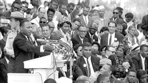 The Rev. Dr. Martin Luther King Jr., head of the Southern Christian Leadership Conference, gestures during his "I Have a Dream" speech as he addresses thousands of civil rights supporters gathered in front of the Lincoln Memorial for the March on Washington for Jobs and Freedom in Washington, D.C., Aug. 28, 1963. Mahalia Jackson is sitting on the right side of the photo and actor-singer Sammy Davis Jr. can be seen at extreme right, bottom. (AP Photo)