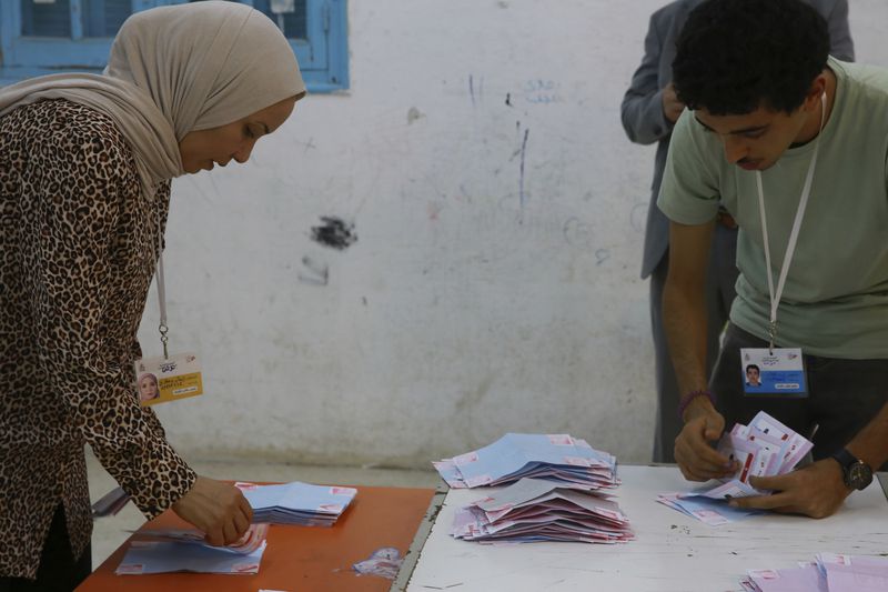 Election officials count the votes after the presidential elections in the capital Tunis, Tunisia, Sunday, Oct. 6, 2024. (AP Photo/Anis Mili)