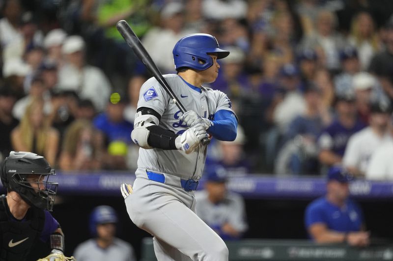 Los Angeles Dodgers' Shohei Ohtani doubles off Colorado Rockies relief pitcher Luis Peralta in the eighth inning of a baseball game, Friday, Sept. 27, 2024, in Denver. (AP Photo/David Zalubowski)