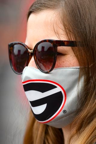 A Georgia fan watches warmups before a football game against Tennessee on Saturday, Oct. 10, 2020, at Sanford Stadium in Athens. JOHN AMIS FOR THE ATLANTA JOURNAL- CONSTITUTION