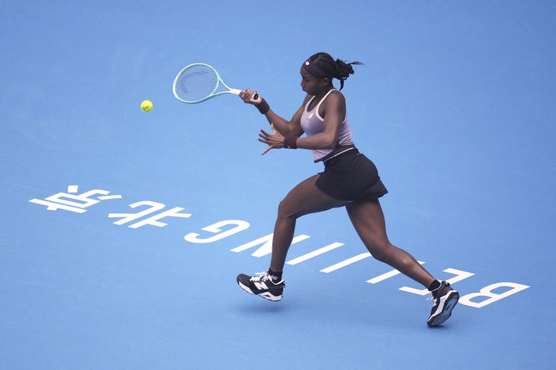 Coco Gauff of the United States returns a shot to Paula Badosa of Spain in a women's singles semi-final match for the China Open tennis tournament at the National Tennis Center in Beijing, Saturday, Oct. 5, 2024. (AP Photo/Achmad Ibrahim)