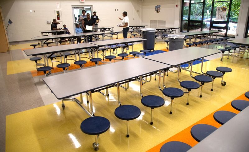 Beecher Hills Elementary school principal Crystal Jones (R) talks to families in the schools’ new cafeteria at the first open house after the schools’ extensive renovation Friday, August 9, 2019. STEVE SCHAEFER / SPECIAL TO THE AJC