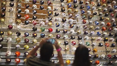 A three-story-high wall of helmets displays the headgear of the 768 teams that play college football at several different levels.