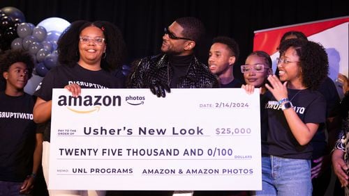 Usher appears with students from his New Look Foundation during a homecoming rally for him at Clark Atlanta University in Atlanta on Wednesday, February 14, 2024. Along with other honors, Amazon presented a $25,000 donation to the New Look Foundation. (Arvin Temkar / arvin.temkar@ajc.com)