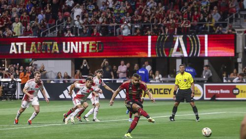 Atlanta United forward Giorgos Giakoumakis (7) kicks a penalty kick and scores a goal during the second half against the New England Revolution at Mercedes-Benz Stadium, Saturday, March 9, 2024, in Atlanta. Atlanta United forward Giorgos Giakoumakis scored three goals in the game. Atlanta United won 4-1. (Jason Getz / jason.getz@ajc.com)