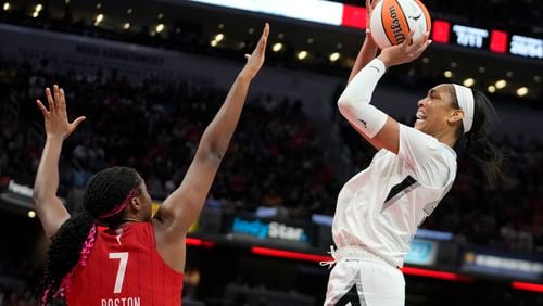 Las Vegas Aces' A'ja Wilson shoots over Indiana Fever's Aliyah Boston (7) during the second half of a WNBA basketball game, Wednesday, Sept. 11, 2024, in Indianapolis. (AP Photo/Darron Cummings)