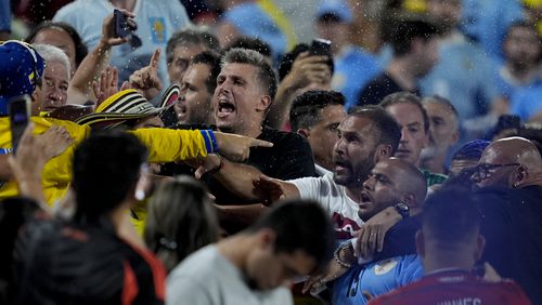 Uruguay's players argue with fans at the end of a Copa America semifinal soccer match against Colombia in Charlotte, N.C., Wednesday, July 10, 2024. (AP Photo/Julia Nikhinson)