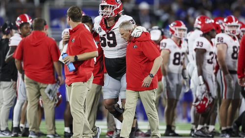 Georgia offensive lineman Tate Ratledge (69) gets help off of the field after getting injured during the first half against Kentucky at Kroger Field, Saturday, Sept. 14, 2024, in Lexington, Kentucky. (Jason Getz / AJC)

