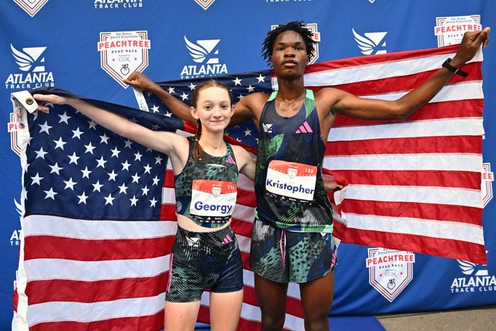 First-place Elite High School runners Georgy Helmers (right) and Kristopher Strong pose for a photograph after the 55th Atlanta Journal-Constitution Peachtree Road Race in Atlanta on Thursday, July 4, 2024.  (Hyosub Shin / Hyosub.Shin / ajc.com)