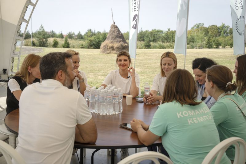 First lady Olena Zelenska talks to a teachers during her visit to the rehabilitation camp "Loud Camp" for children affected by war, organized by the Voices of Children Charitable Foundation and financially supported by the Olena Zelenska Foundation in Uzhhorod, Ukraine, Tuesday, Aug. 27, 2024. (AP Photo/Efrem Lukatsky)