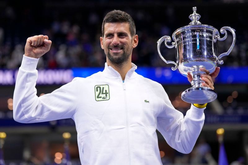 FILE - Novak Djokovic, of Serbia, holds up the championship trophy after defeating Daniil Medvedev, of Russia, in the men's singles final of the U.S. Open tennis championships, Sunday, Sept. 10, 2023, in New York. (AP Photo/Manu Fernandez, File)