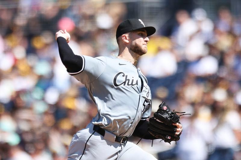 Chicago White Sox starting pitcher Sean Burke winds up against a San Diego Padres' batter in the first inning of a baseball game, Sunday, Sept. 22, 2024, in San Diego. (AP Photo/Derrick Tuskan)