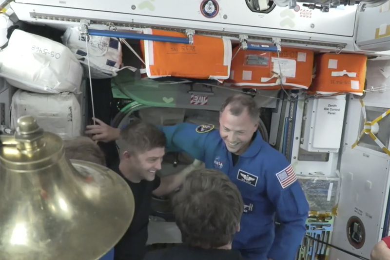 NASA’s Nick Hague in blue enters the International Space Station from the SpaceX capsule Dragon, Sunday, Sept. 29, 2024. (NASA via AP)