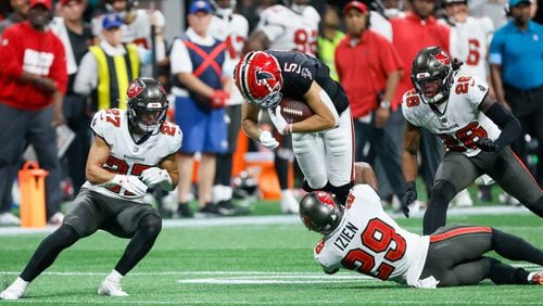 Atlanta Falcons wide receiver Drake London (5) gets tackled after a catch during overtime of an NFL football game against the Tampa Bay Buccaneers on Thursday, October 3, 2024, at Mercedes-Benz Stadium in Atlanta. 
(Miguel Martinez/ AJC)