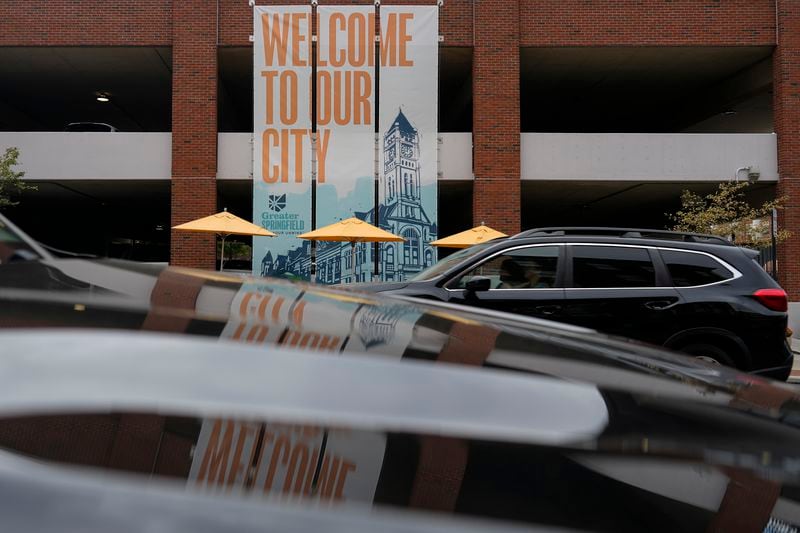 A banner with the images of the Heritage Center of Clark County and "Welcome To Our City," hangs along North Fountain Ave. Tuesday, Sept. 17, 2024, in Springfield, Ohio. (AP Photo/Carolyn Kaster)