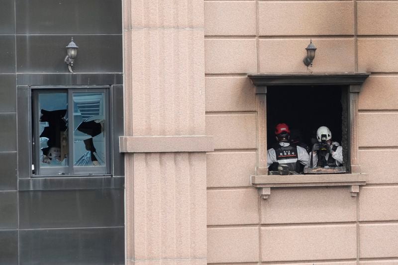 A joint investigation team examines the site of a hotel burnt by Thrusday's fire in Bucheon, South Korea, Friday, Aug. 23, 2024. (AP Photo/Ahn Young-joon)