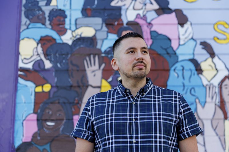 Luis A. Torres stands for a portrait in front of the " Joy is the Fuel" mural by Cuban-American artist Alma Landeta at the SF LGBT Center on Friday, Sept. 20, 2024, in San Francisco. (AP Photo/Juliana Yamada)