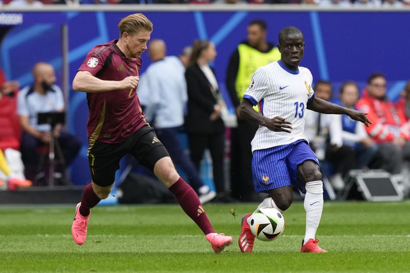 Belgium's Kevin De Bruyne, left, and N'Golo Kante of France vie for the ball during a round of sixteen match between France and Belgium at the Euro 2024 soccer tournament in Duesseldorf, Germany, Monday, July 1, 2024. (AP Photo/Frank Augstein)
