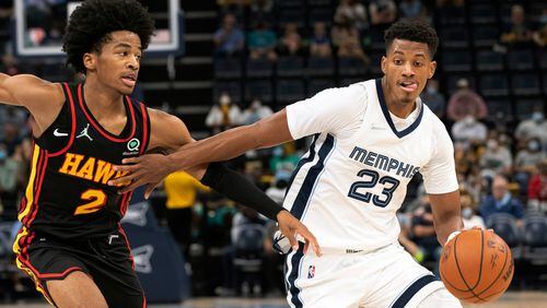 Memphis Grizzlies guard Jarrett Culver (23) drives to the basket defended by Hawks guard Sharife Cooper (2) in the second half of a preseason game Saturday, Oct. 9, 2021, in Memphis, Tenn. (Nikki Boertman/AP)