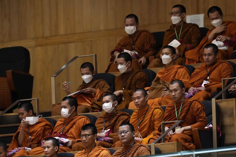 Thai Buddhist monks watch a debate before a vote to select the new prime minister at the Parliament in Bangkok, Thailand, Friday, Aug. 16, 2024, (AP Photo/Sakchai Lalit)