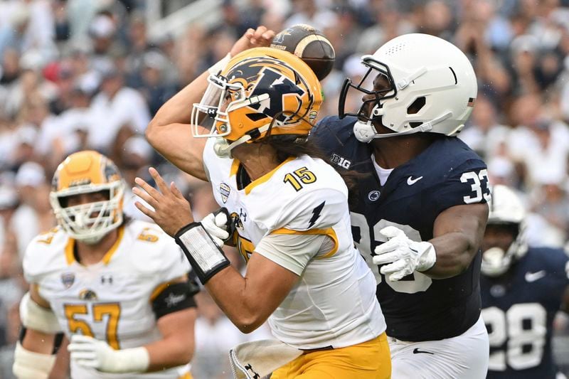 Penn State defensive end Dani Dennis-Sutton tackles Kent State quarterback Devin Kargman during the first quarter of an NCAA college football game, Saturday, Sept. 21, 2024, in State College, Pa. (AP Photo/Barry Reeger)